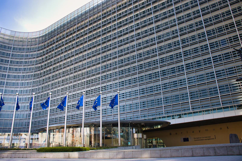 Modern glass building with european union flags