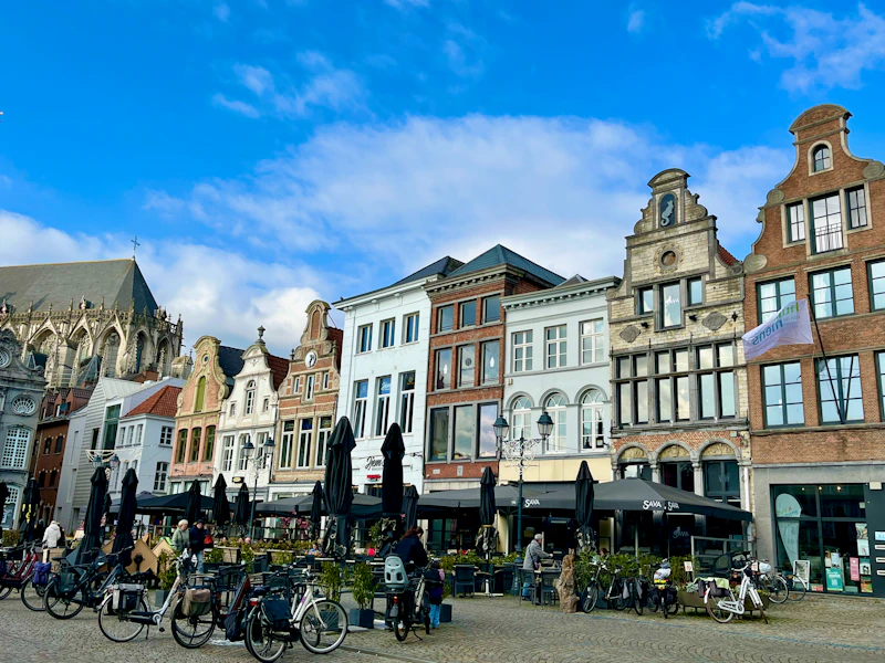 Historic buildings line a plaza with bicycles.